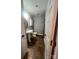 Compact bathroom with a pedestal sink, tiled floor, and modern fixtures at 208 Stone Ridge Dr, Salisbury, NC 28146