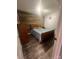 Cozy bedroom featuring wood accent wall, hardwood floors, and natural light at 208 Stone Ridge Dr, Salisbury, NC 28146