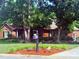 Charming brick home with a beautifully landscaped front yard featuring lush greenery and vibrant flower beds at 208 Stone Ridge Dr, Salisbury, NC 28146