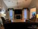 Inviting living room with a fireplace, a TV, and French doors leading to the backyard at 208 Stone Ridge Dr, Salisbury, NC 28146