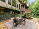Backyard stone patio with ivy growing up the house and a four-chair table set at 218 Point Carpenter Rd, Fort Mill, SC 29707