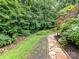 Beautiful backyard pathway leading to a tranquil garden area, perfect for relaxation and enjoying nature at 218 Point Carpenter Rd, Fort Mill, SC 29707