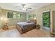Cozy bedroom with a ceiling fan and wooded views, with access to a private balcony at 218 Point Carpenter Rd, Fort Mill, SC 29707