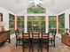 Inviting dining area with a ceiling fan and natural light pouring in from the surrounding forest views at 218 Point Carpenter Rd, Fort Mill, SC 29707