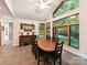 Bright dining room with vaulted ceilings, large windows with wooded views and statement lighting at 218 Point Carpenter Rd, Fort Mill, SC 29707