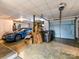Spacious garage featuring a blue sports car, a blue door, and shelving units at 218 Point Carpenter Rd, Fort Mill, SC 29707