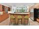 Modern kitchen with wood cabinetry, a large island with seating, and natural light creating a welcoming atmosphere at 218 Point Carpenter Rd, Fort Mill, SC 29707