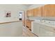 Bright laundry room featuring wood cabinets and modern washer and dryer units at 218 Point Carpenter Rd, Fort Mill, SC 29707
