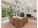 Open living room with soaring windows, stone fireplace, and comfortable seating, bringing the outdoors in at 218 Point Carpenter Rd, Fort Mill, SC 29707
