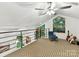 Bright loft with a cozy seating area and large windows overlooking the private wooded landscape at 218 Point Carpenter Rd, Fort Mill, SC 29707
