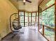 Cozy screened porch features a hanging chair, wooded views, and ample natural light at 218 Point Carpenter Rd, Fort Mill, SC 29707