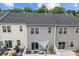 Exterior view of backyard patios with seating areas, a shade sail, and well-maintained landscaping at 2444 Mariners Cove Ln, Denver, NC 28037