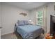 Cozy bedroom with a comfortable bed, a decorative wall hanging, and a window providing natural light at 2444 Mariners Cove Ln, Denver, NC 28037