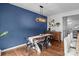 Dining room with a rustic table and modern light fixture with direct access to the kitchen at 2444 Mariners Cove Ln, Denver, NC 28037