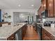 Spacious kitchen showcasing granite countertops, wooden cabinetry, and modern stainless-steel appliances at 2444 Mariners Cove Ln, Denver, NC 28037