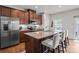 Well-lit kitchen features stainless steel appliances, granite countertops, and a central island with barstool seating at 2444 Mariners Cove Ln, Denver, NC 28037