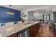 Open concept kitchen with granite countertops, stainless steel appliances, island with sink and seating overlooking living and dining area at 2444 Mariners Cove Ln, Denver, NC 28037