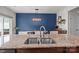 Kitchen island featuring granite countertops, stainless steel sink and faucet overlooking the dining room at 2444 Mariners Cove Ln, Denver, NC 28037