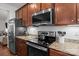Modern kitchen with updated appliances, granite countertops, and subway tile backsplash, and wooden cabinets at 2444 Mariners Cove Ln, Denver, NC 28037