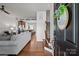 Inviting open-concept living room boasts wood floors, flowing into a modern kitchen with stainless steel appliances at 2444 Mariners Cove Ln, Denver, NC 28037
