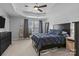 A bright and spacious main bedroom features a dark-colored bed frame, white shiplap walls, and a walk-in closet at 2444 Mariners Cove Ln, Denver, NC 28037