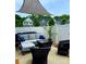 Inviting patio area featuring comfortable furniture, a shade covering, and a view of the surrounding greenery at 2444 Mariners Cove Ln, Denver, NC 28037