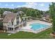 A view of the large, inviting pool area with an adjacent home and deck at 2444 Mariners Cove Ln, Denver, NC 28037