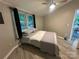 Cozy bedroom features a comfortable bed, wood-look tile flooring, and peaceful window views at 295 Rendleman Rd, Salisbury, NC 28146