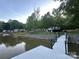 Scenic view of the waterfront property featuring a dock extending into the calm waters of the lake at 295 Rendleman Rd, Salisbury, NC 28146