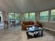 Inviting living room featuring large windows, a modern leather couch, and a stylish glass coffee table at 295 Rendleman Rd, Salisbury, NC 28146