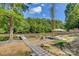 Backyard lakeside view with dock, lounge area, and lush trees on a sunny day at 295 Rendleman Rd, Salisbury, NC 28146