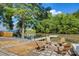 Inviting backyard featuring a fire pit, wooden chairs, and dock access to the serene waterfront at 295 Rendleman Rd, Salisbury, NC 28146