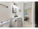Modern bathroom features updated vanity, stylish mirror, and sleek black tile accents in the shower at 295 Rendleman Rd, Salisbury, NC 28146
