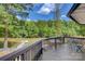 Spacious deck with a view of the lake and a dock surrounded by lush green trees at 295 Rendleman Rd, Salisbury, NC 28146