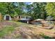 Lakeside backyard features a deck, patio, lounge area, dock, and grassy lawn surrounded by trees at 295 Rendleman Rd, Salisbury, NC 28146