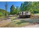 Home with a deck overlooking the lake features waterfront lounging and dock amidst lush trees at 295 Rendleman Rd, Salisbury, NC 28146