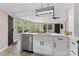 Bright kitchen featuring island with sink, stainless steel appliances, and modern light fixture at 295 Rendleman Rd, Salisbury, NC 28146
