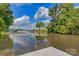 Picturesque waterfront view showcasing a serene lake and neighboring houses at 295 Rendleman Rd, Salisbury, NC 28146