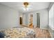 Bedroom with wood floors, ceiling fan, and access to an ensuite bathroom and kitchen at 317 Cedarcroft Dr, Mooresville, NC 28115
