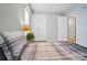 Bedroom featuring neutral walls, wood-look flooring, and a view of a large closet at 317 Cedarcroft Dr, Mooresville, NC 28115