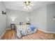 Bright bedroom with wood floors, ceiling fan, and ample natural light at 317 Cedarcroft Dr, Mooresville, NC 28115