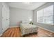 Bright bedroom features laminate flooring, a window, and a closet at 317 Cedarcroft Dr, Mooresville, NC 28115