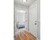 Bright hallway leading to a bedroom with neutral décor and wood-look flooring at 317 Cedarcroft Dr, Mooresville, NC 28115