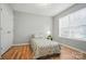 Bright bedroom features laminate flooring, a window, and a closet at 317 Cedarcroft Dr, Mooresville, NC 28115