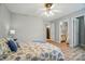 Bright bedroom featuring a ceiling fan, neutral walls, and doorway to kitchen and bathroom at 317 Cedarcroft Dr, Mooresville, NC 28115
