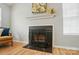 Elegant fireplace with mantel, decorative artwork, and window views at 317 Cedarcroft Dr, Mooresville, NC 28115