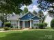 Charming single-story home featuring a well-manicured lawn and inviting front entrance, perfect for a cozy lifestyle at 317 Cedarcroft Dr, Mooresville, NC 28115