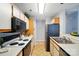 Galley-style kitchen featuring white countertops, stainless steel appliances, and ceramic tile flooring at 317 Cedarcroft Dr, Mooresville, NC 28115