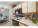 Kitchen featuring white cabinets, black appliances, and warm wood accents at 317 Cedarcroft Dr, Mooresville, NC 28115