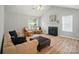 Inviting living room with vaulted ceiling, cozy fireplace, and abundant natural light at 317 Cedarcroft Dr, Mooresville, NC 28115